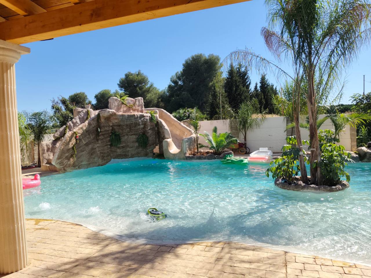 Piscina rehabilitada con cascada y roca